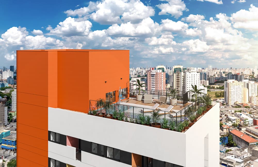 Vista aérea da fachada superior do prédio com a área da piscina e o volume laranja.