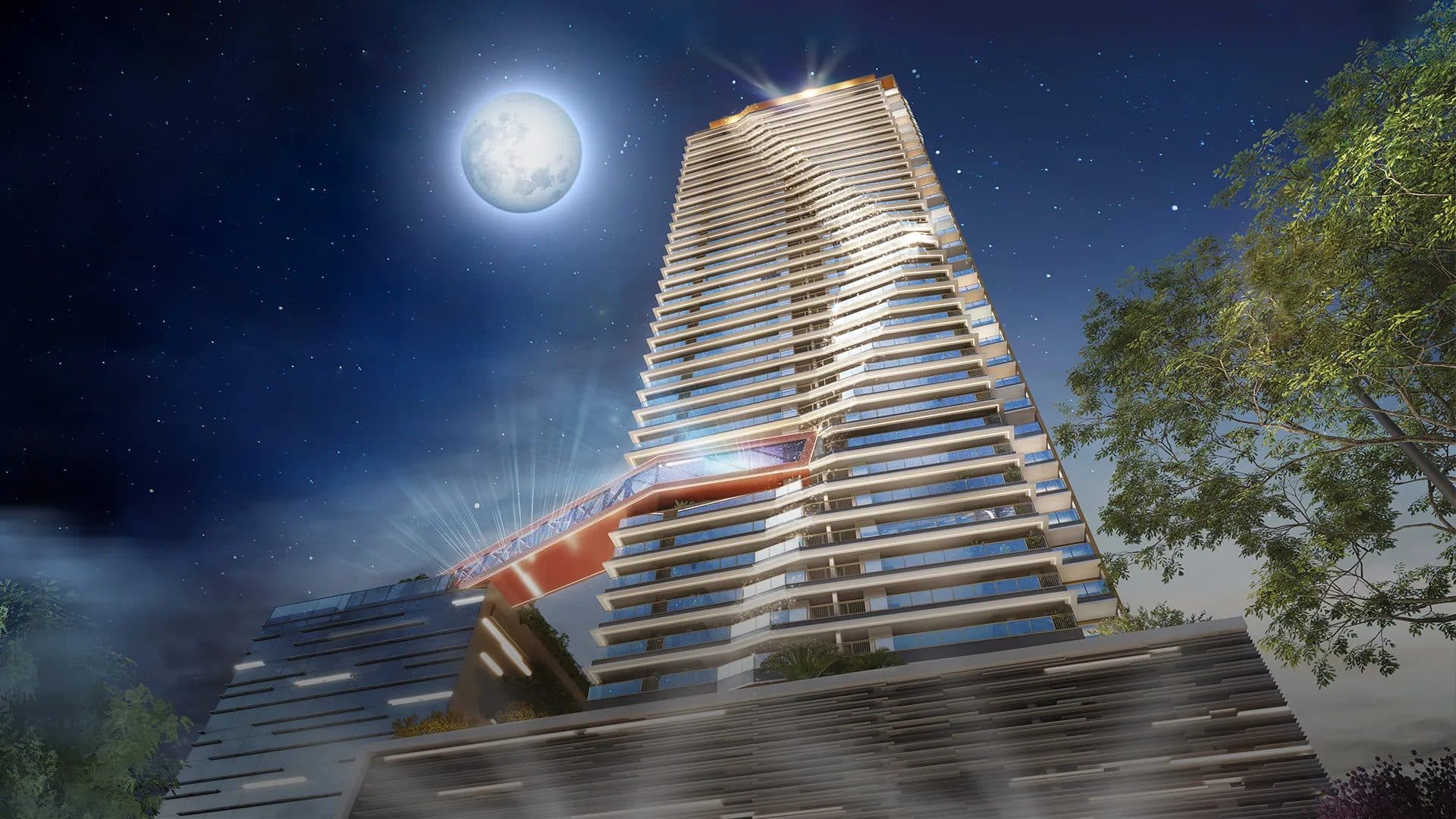 Fachada noturna de edifício residencial de alto padrão com iluminação em destaque e paisagismo.