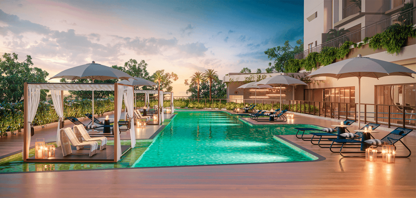 Piscina externa com espreguiçadeiras e gazebos sob iluminação de entardecer.